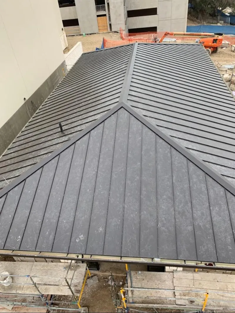 Commercial metal roof construction with crane equipment in Middle Valley